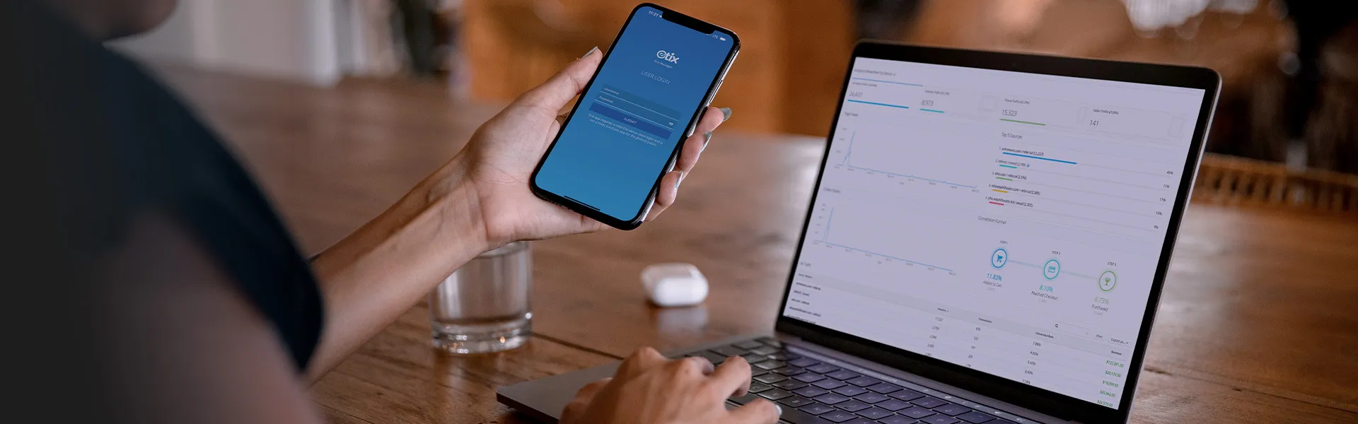 Woman checking event report on phone using Etix Box Office