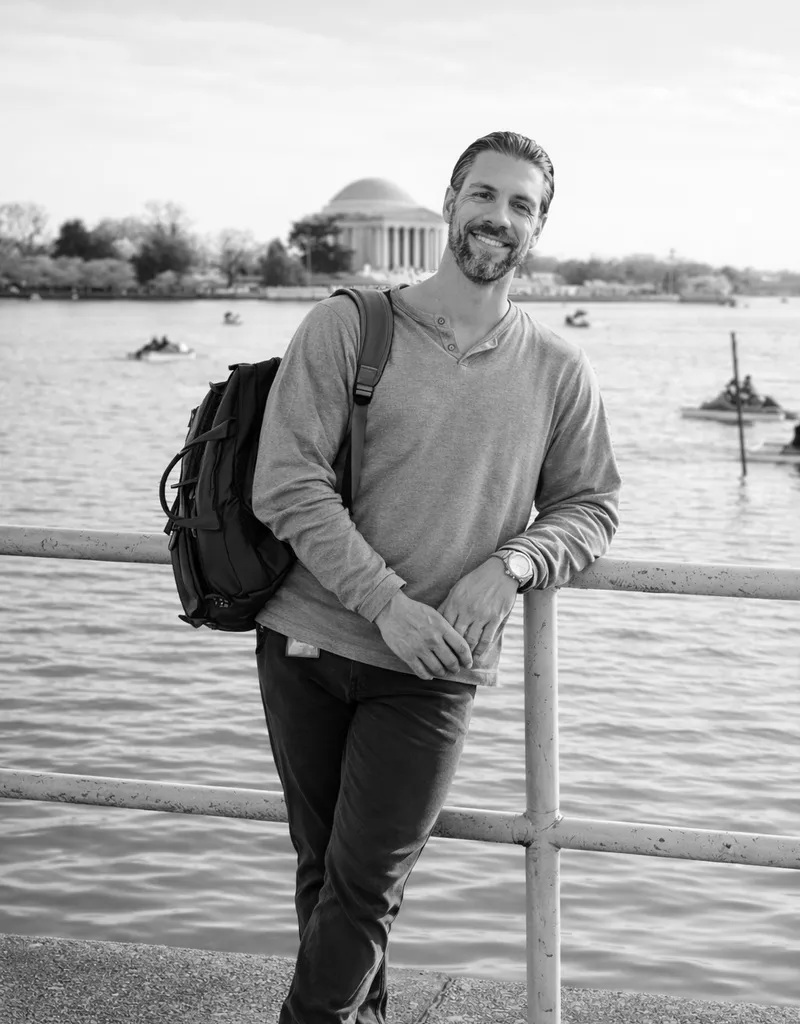 JJ standing in front of a body of water